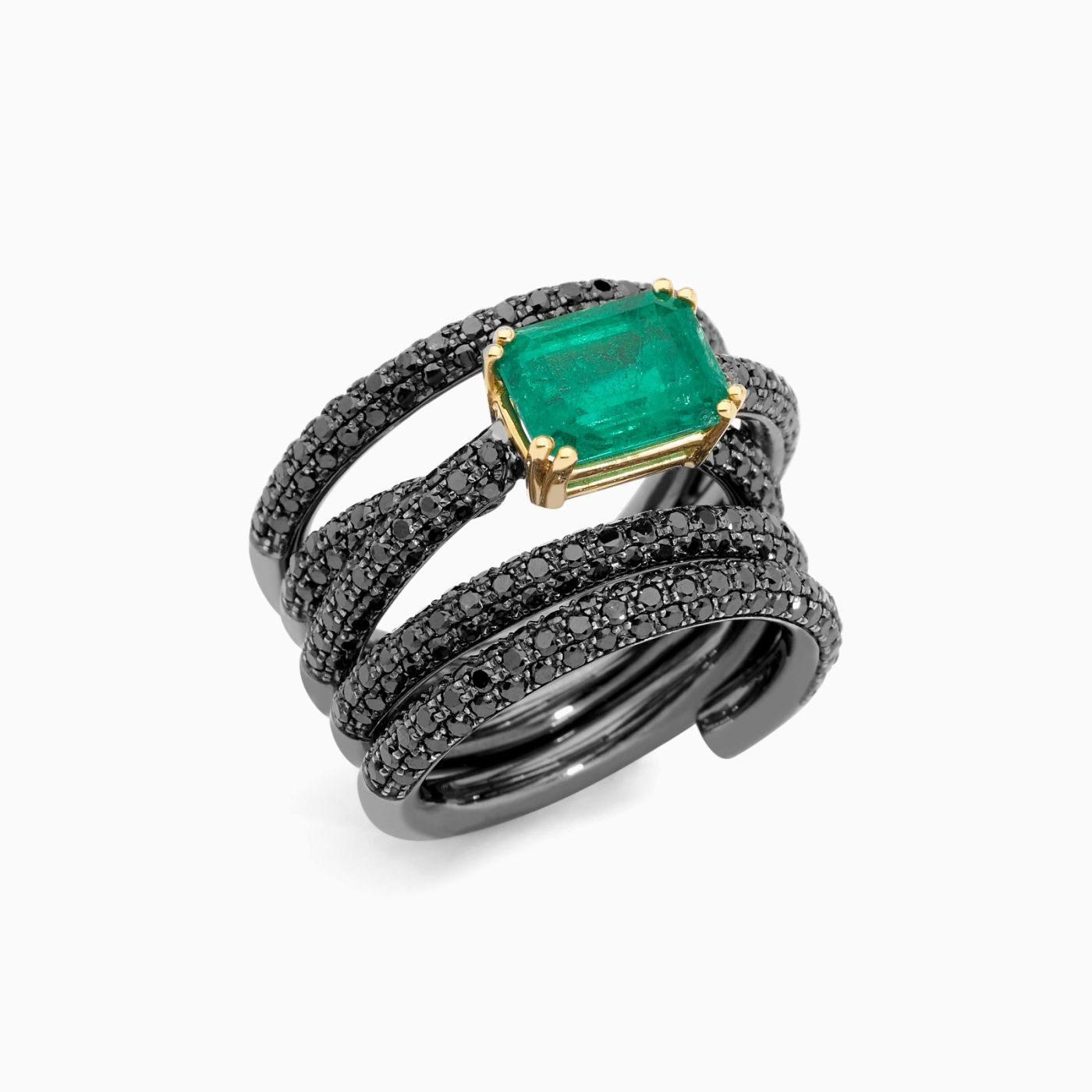 Anillo de oro con rodio negro con esmeralda central y brazo entrelazado con pavé de diamantes negros
