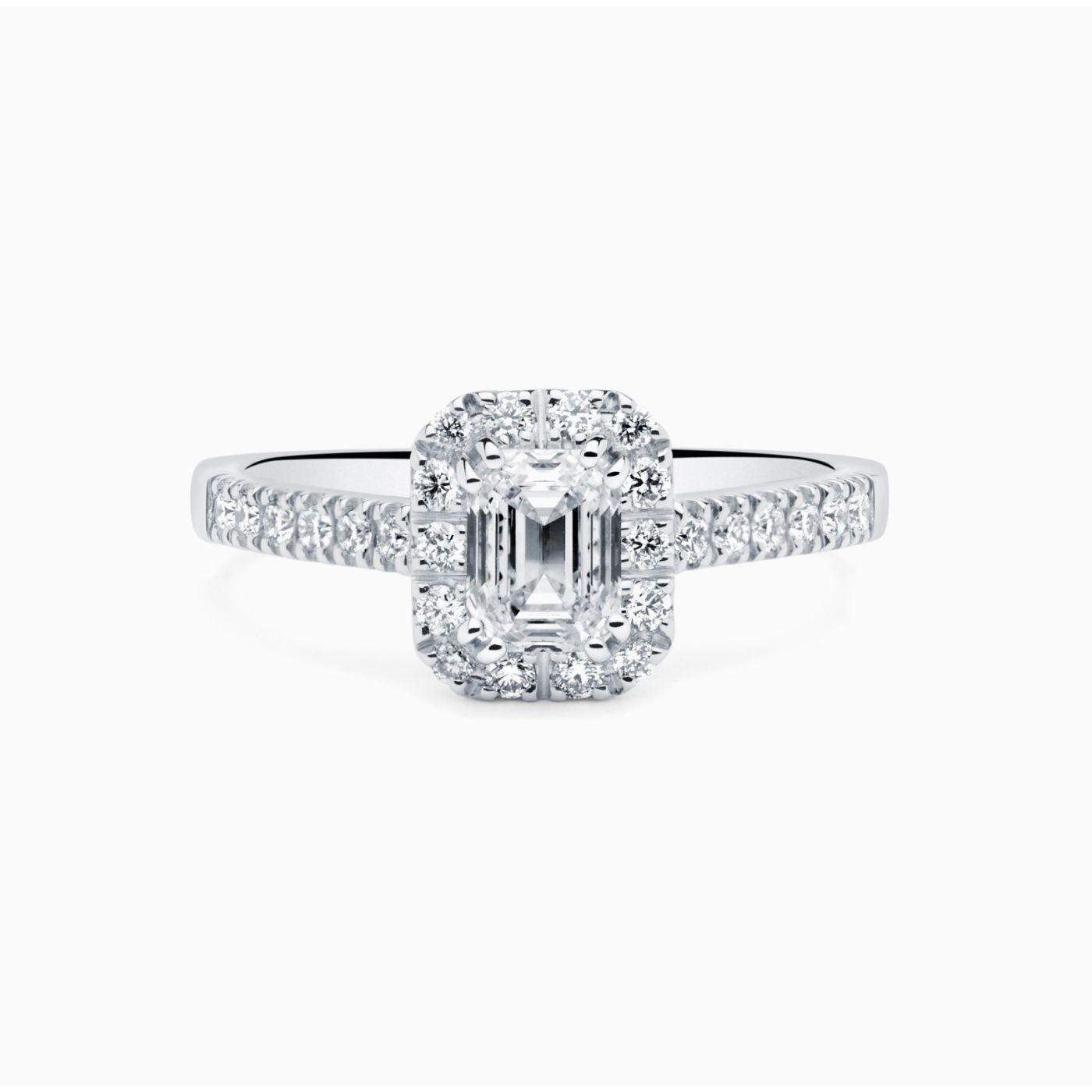 White gold solitaire engagement ring with emerald-cut central diamond and diamond halo