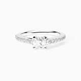 White gold solitaire engagement with an oval-cut central diamond and diamond band