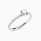 White gold solitaire engagement ring with a central diamond and diamond band