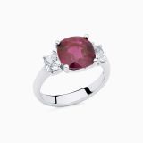 White gold with a ruby in the center and diamonds in the side solitaire ring