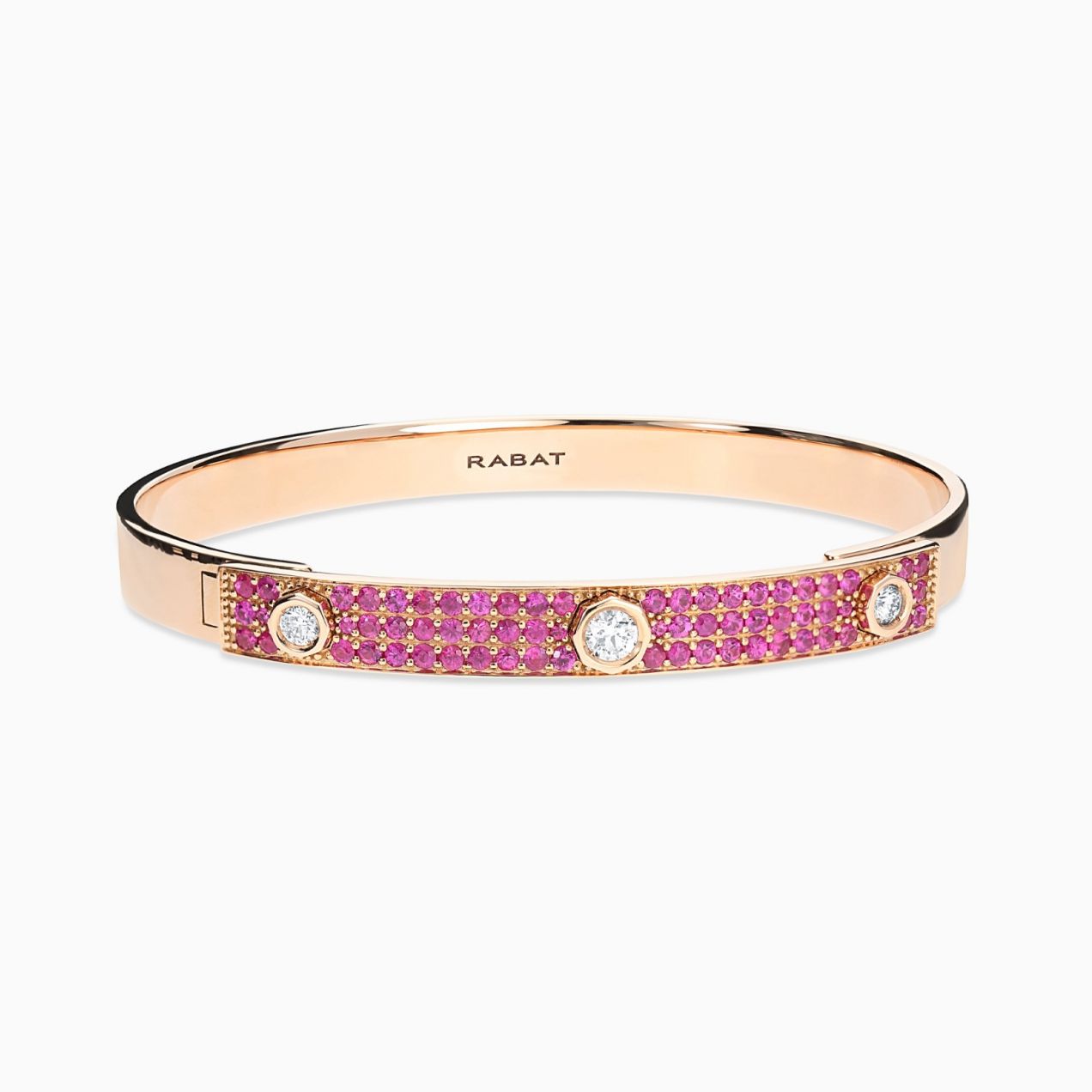 Rose gold bracelet with three central diamonds and red rubies pavé