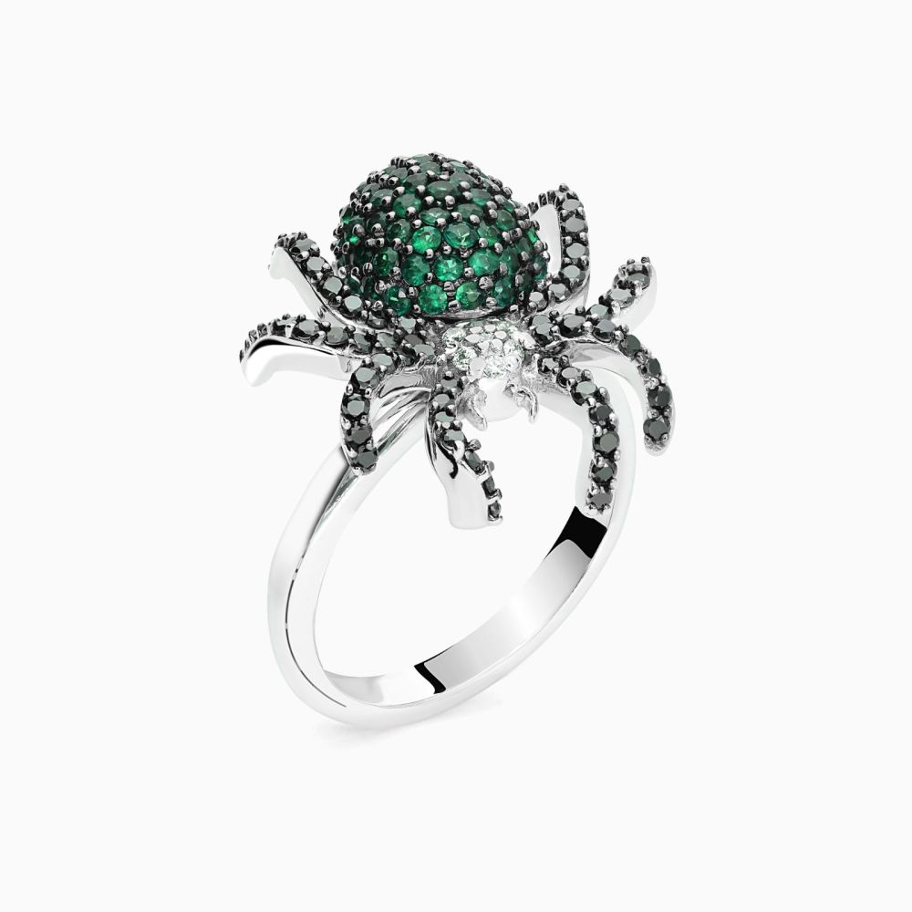 White gold spider ring with diamonds and green emeralds